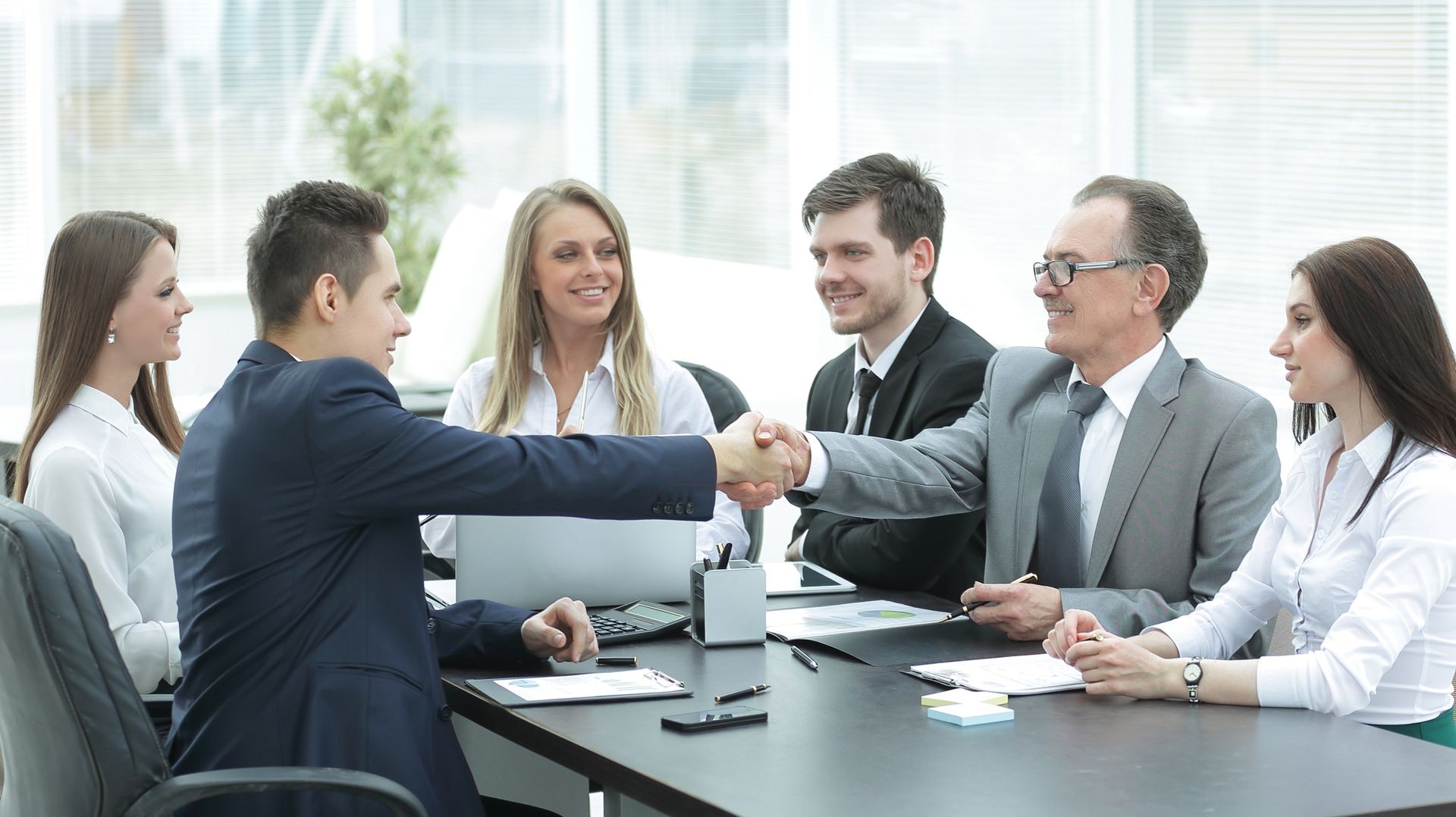 business partners shaking hands after a successful transaction